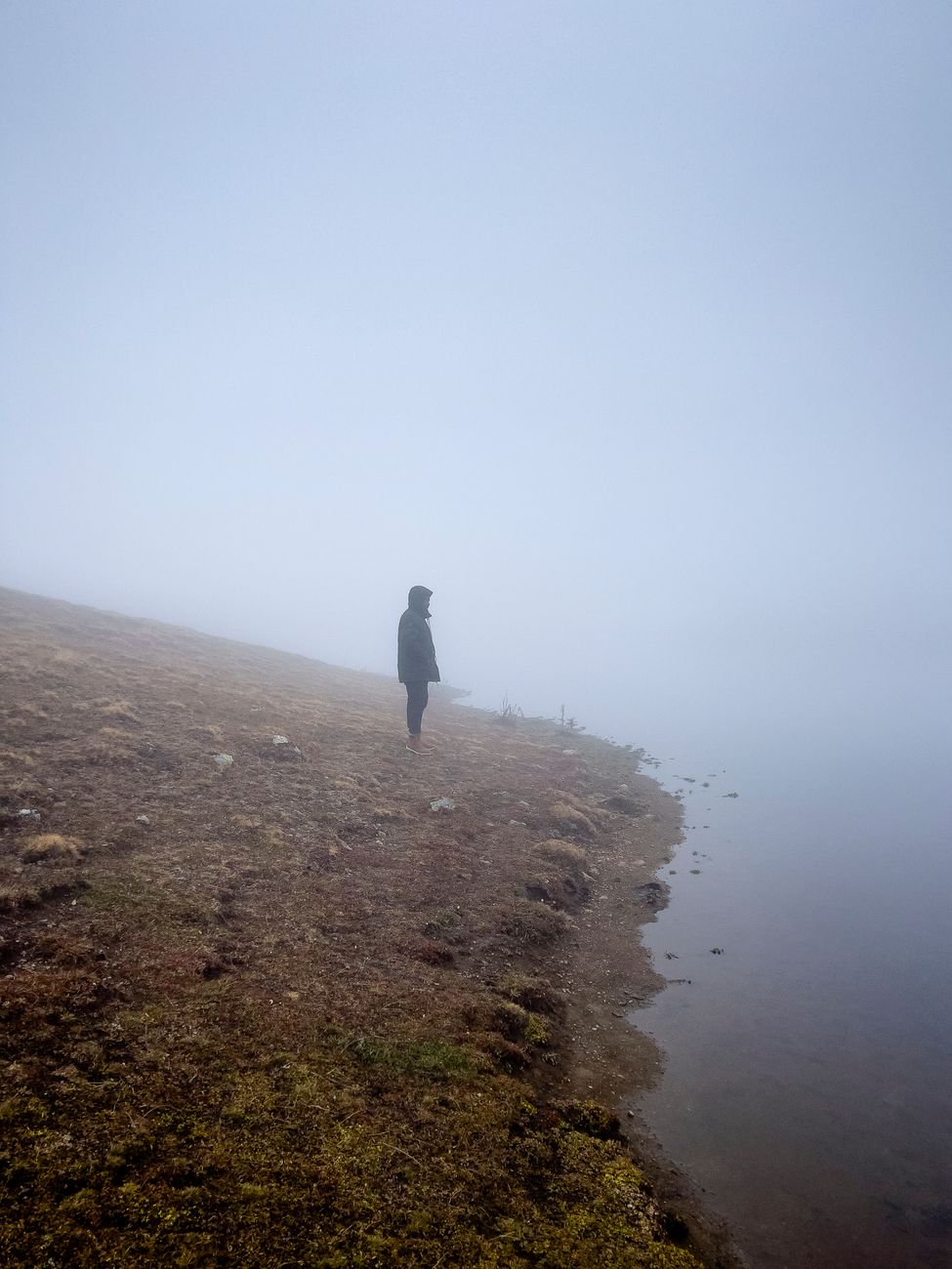 Wanderer observing pristine misty mountains